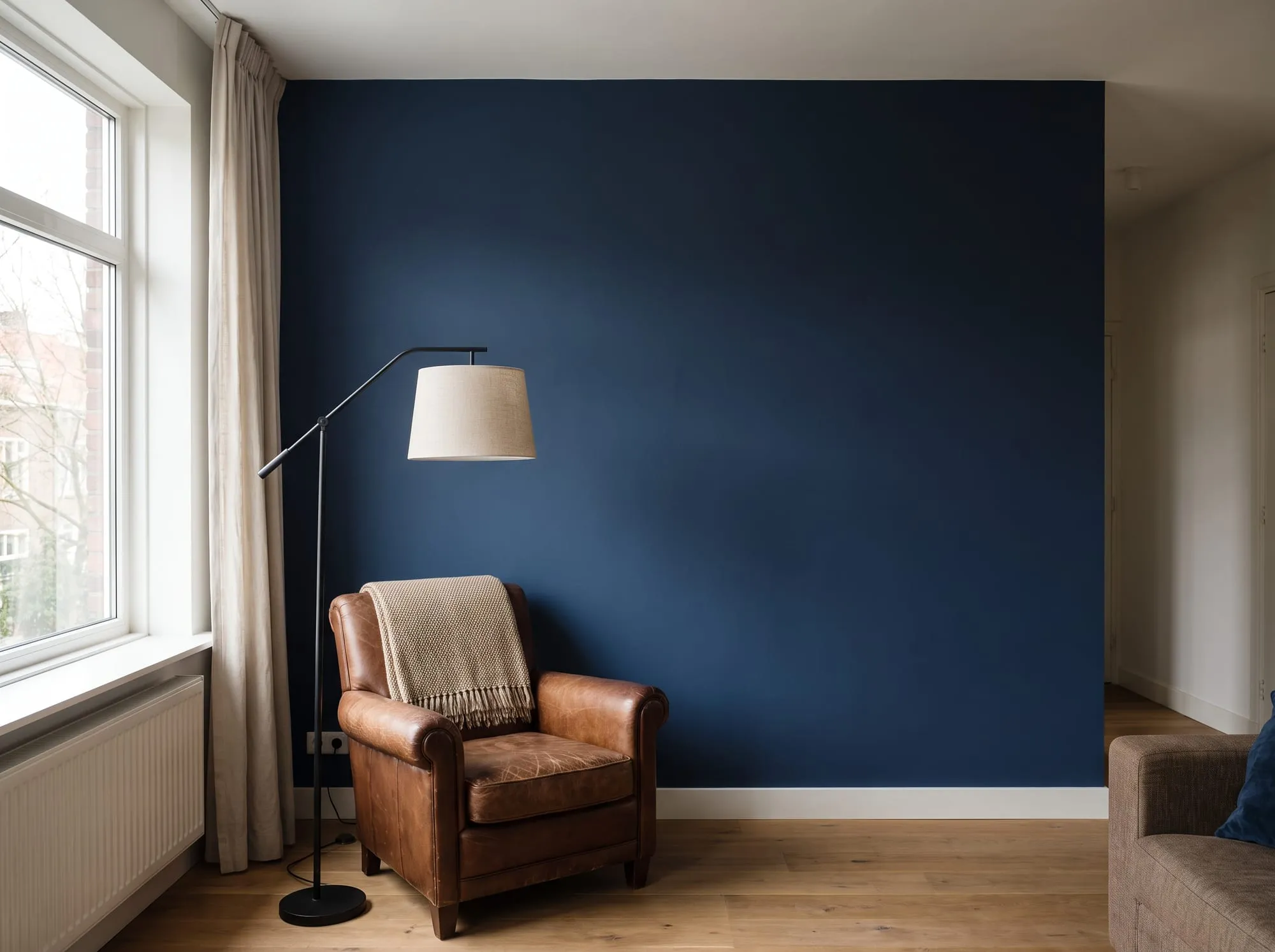 Living room with a seamless navy accent wall where an old opening was closed in