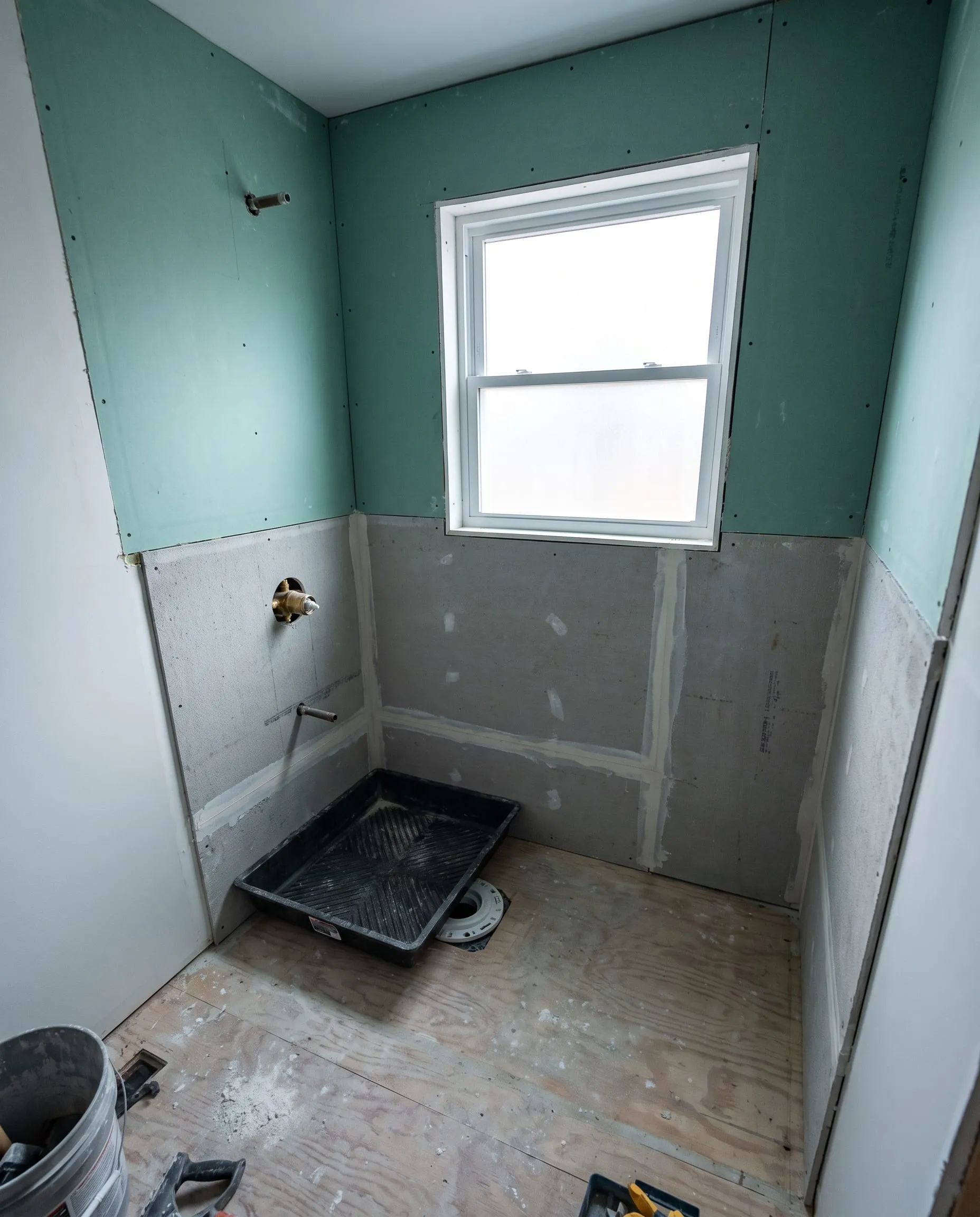 Bathroom remodel with moisture-resistant drywall and cement backer board installed