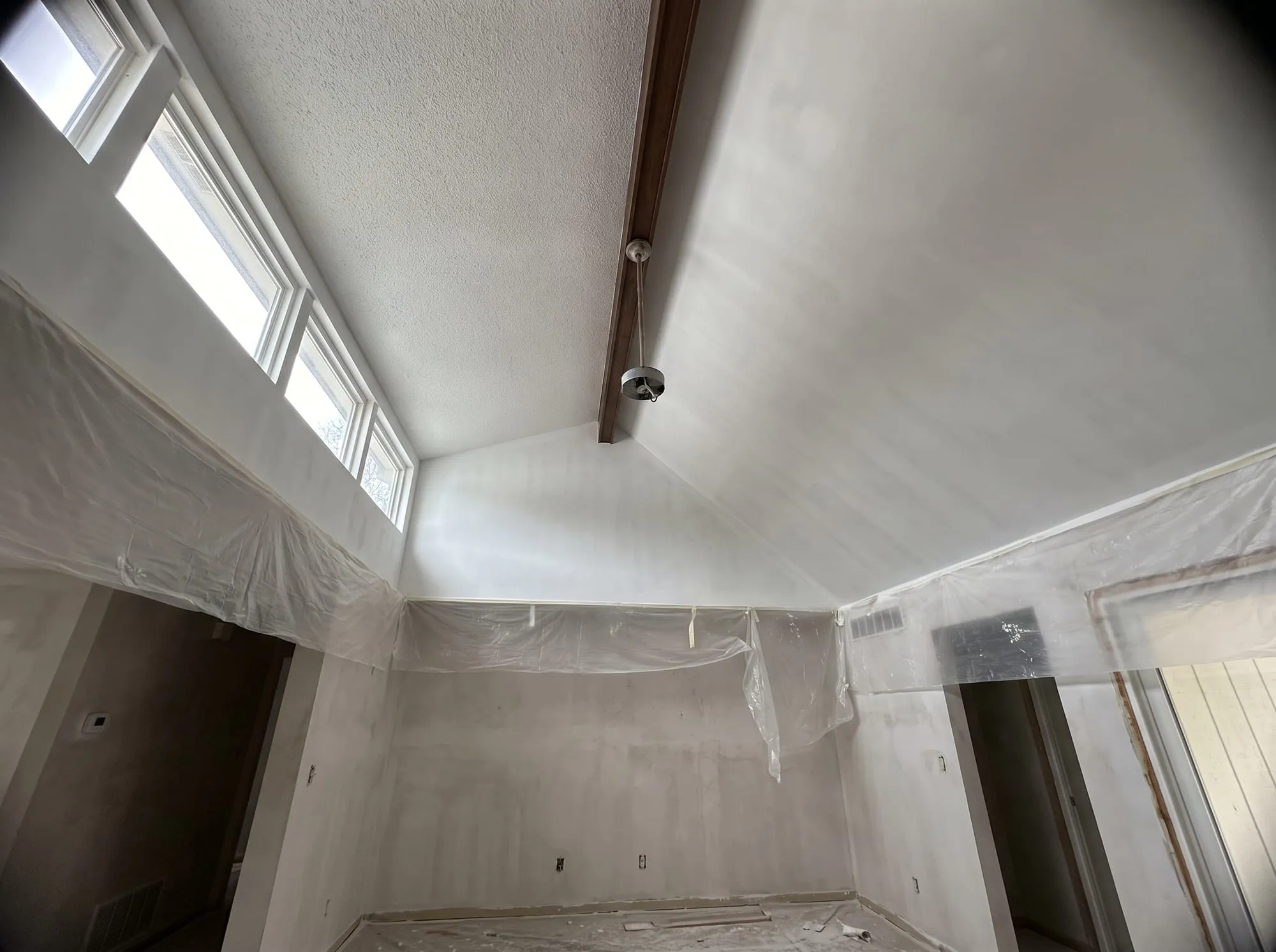 Vaulted living room ceiling converted from popcorn texture to a smooth primed finish